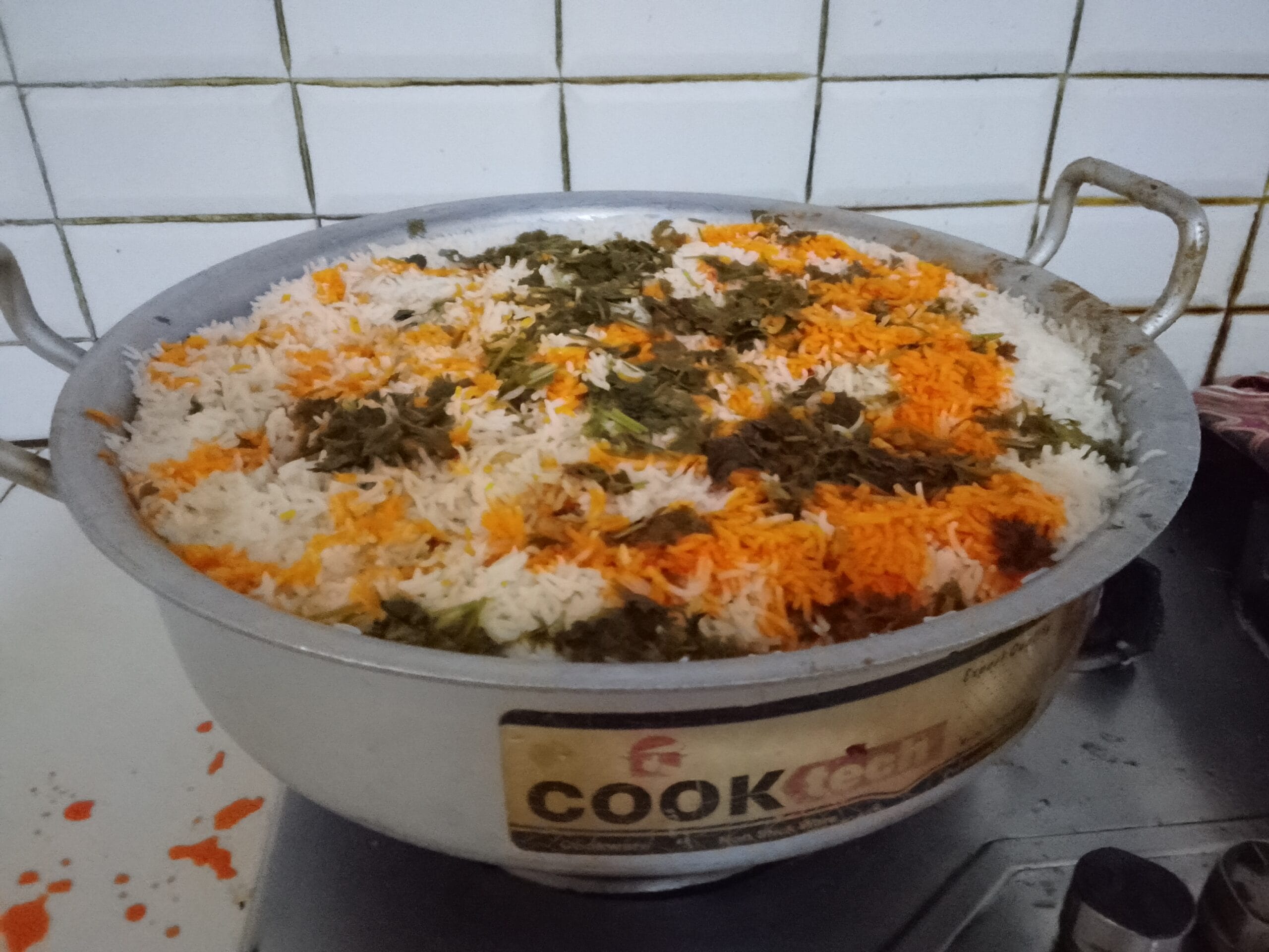Best Homemade Spicy Biryani Recipe – Layering fried onions, mint leaves, and basmati rice over chicken masala for dum