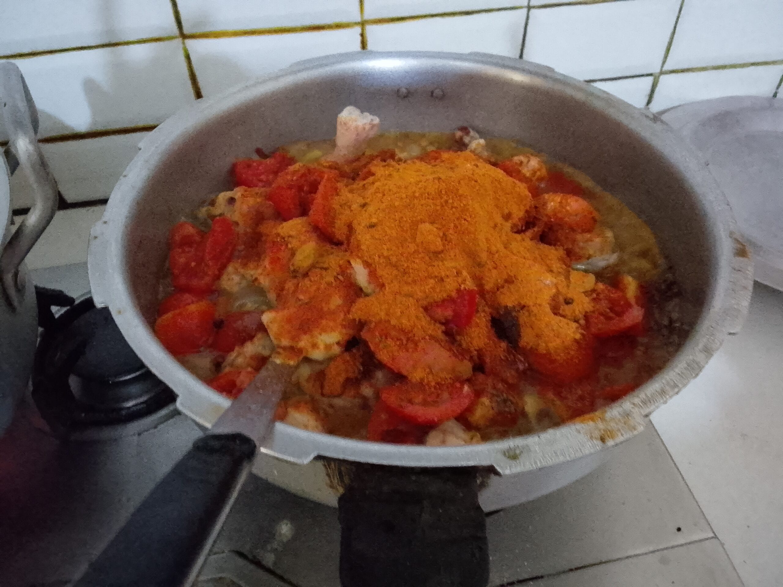 Best Homemade Spicy Biryani Recipe – Adding chopped tomatoes and spices to the chicken masala for rich flavor