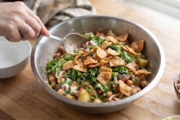 Final bowl of Pakistani Chana Chaat Recipe garnished with fresh coriander, mint, and a handful of crunchy papr