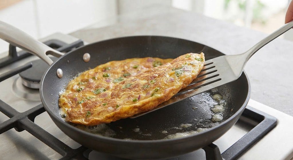 Flipping the masala omelette in a pan