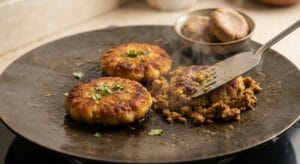 A crispy paratha rolled with fried and mashed Shami kababs, onions, green chillies, and chutney. Keyword: Shami Kabab Paratha Roll