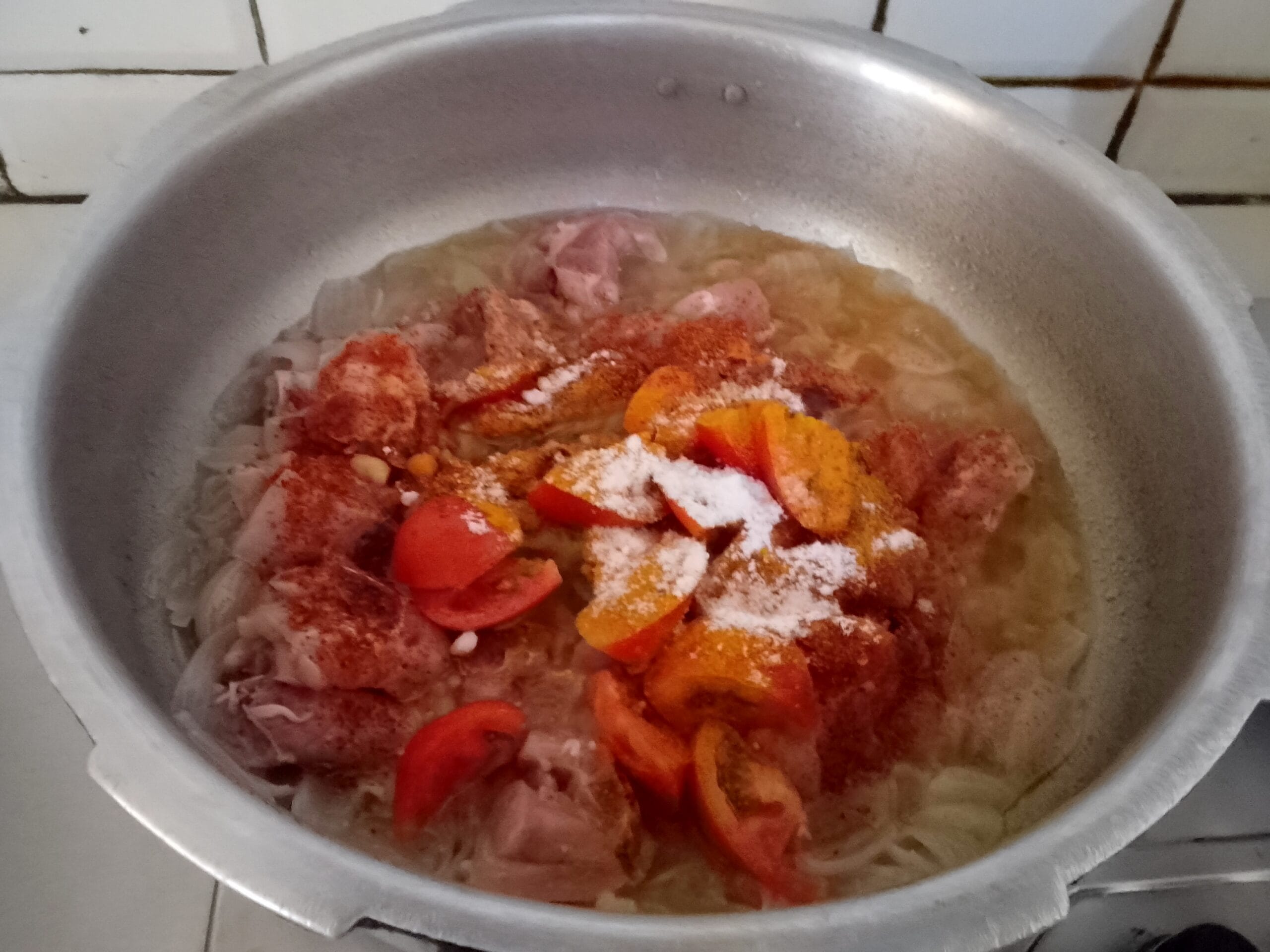 Step of frying golden brown onions in a pot for the best Aloo Chicken Recipe.