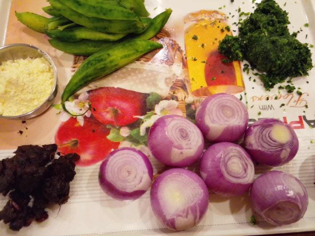 Fresh ingredients including bitter gourd and spices arranged for Masala Bharre Karele recipe